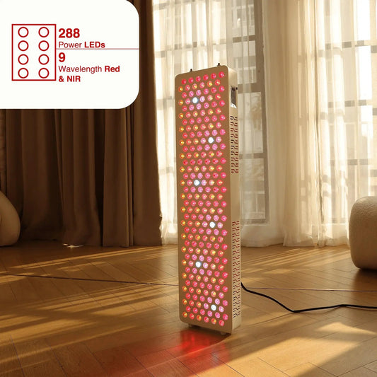 Red light therapy panel standing on a wood floor by a sunlit window, glowing red