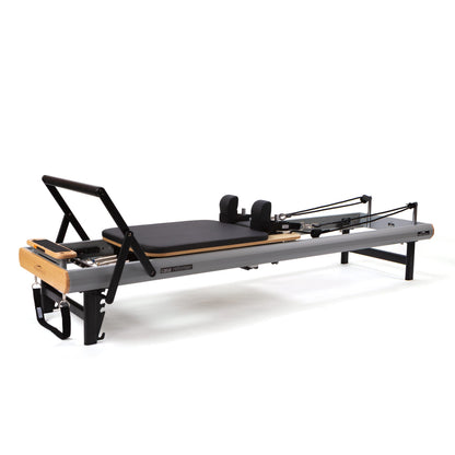 Peak Pilates casa Reformer with Long/Short Box, angled side view of the studio-height powder-coated aluminum frame and carriage