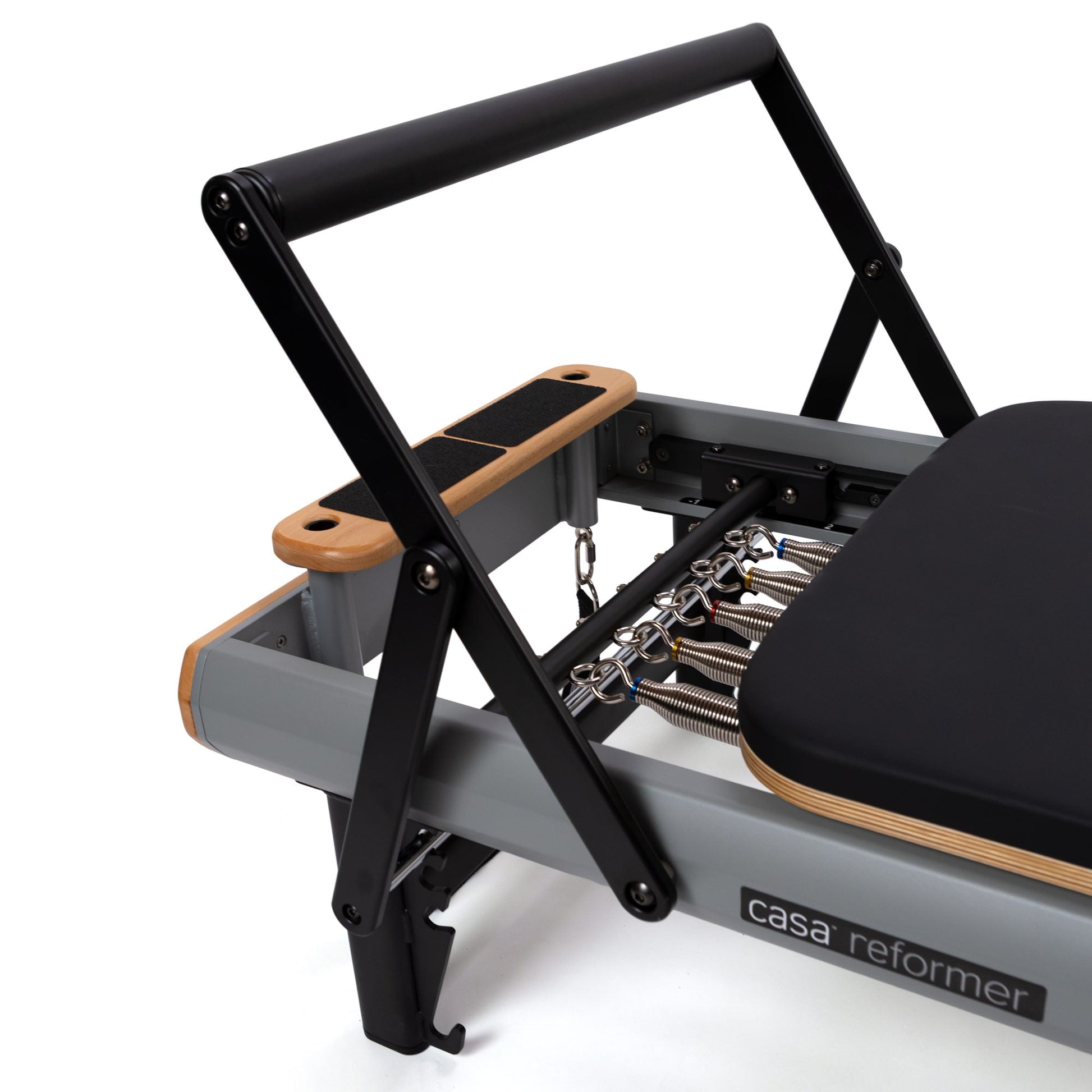Peak Pilates casa Reformer with Long/Short Box, close-up of the five-spring color-coded resistance system and gear bar