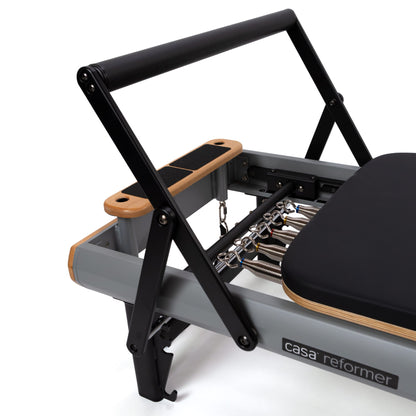 Peak Pilates casa Reformer with Long/Short Box, close-up of the five-spring color-coded resistance system and gear bar