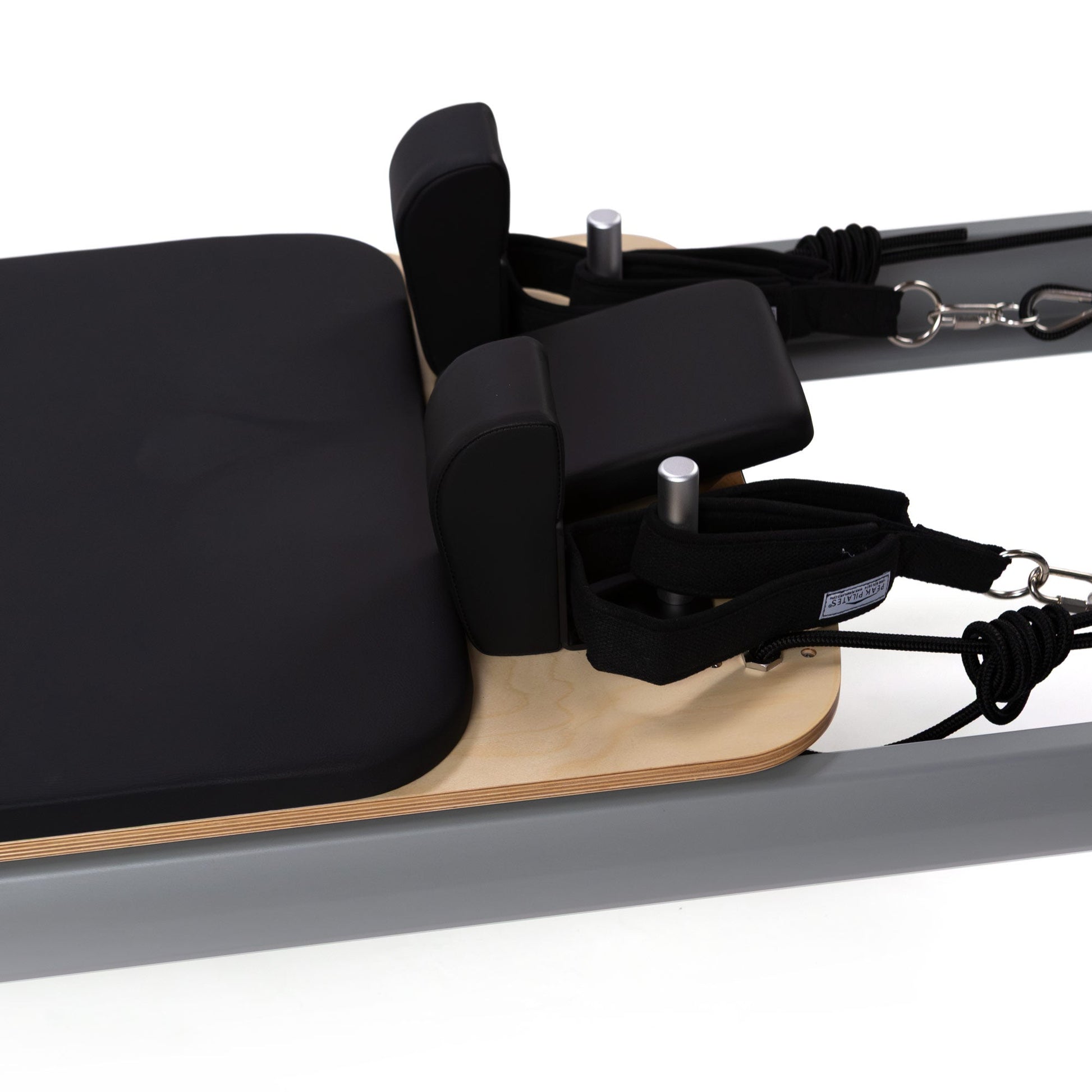 Peak Pilates casa Reformer with Long/Short Box, close-up of the padded three-position headrest and black upholstered carriage