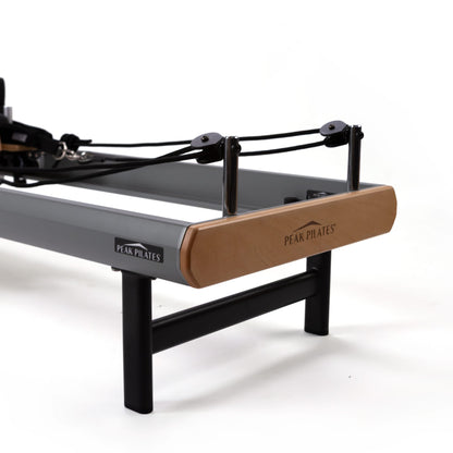 Peak Pilates casa Reformer with Long/Short Box, close-up detail of the wood-and-aluminum end panel and carriage construction