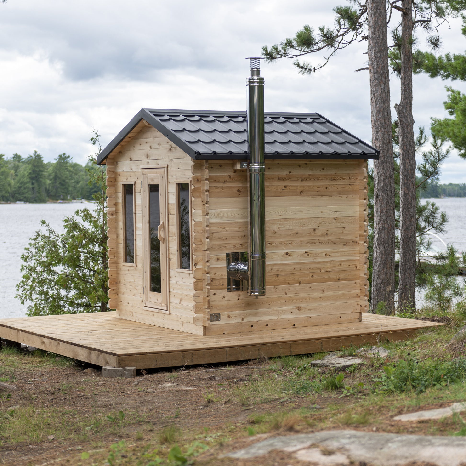 Canadian Timber Georgian 6-person white cedar cabin sauna, installed at the water's edge
