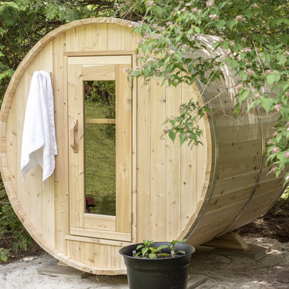 Canadian Timber Harmony 4-person white cedar barrel sauna, installed in a garden setting