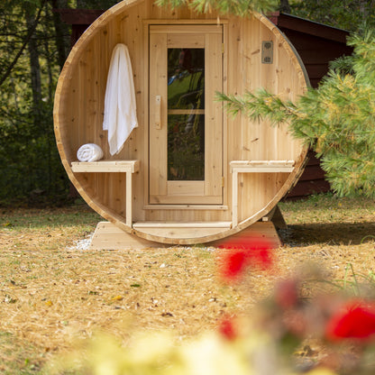 Canadian Timber Serenity 5-person white cedar barrel sauna, installed in a backyard