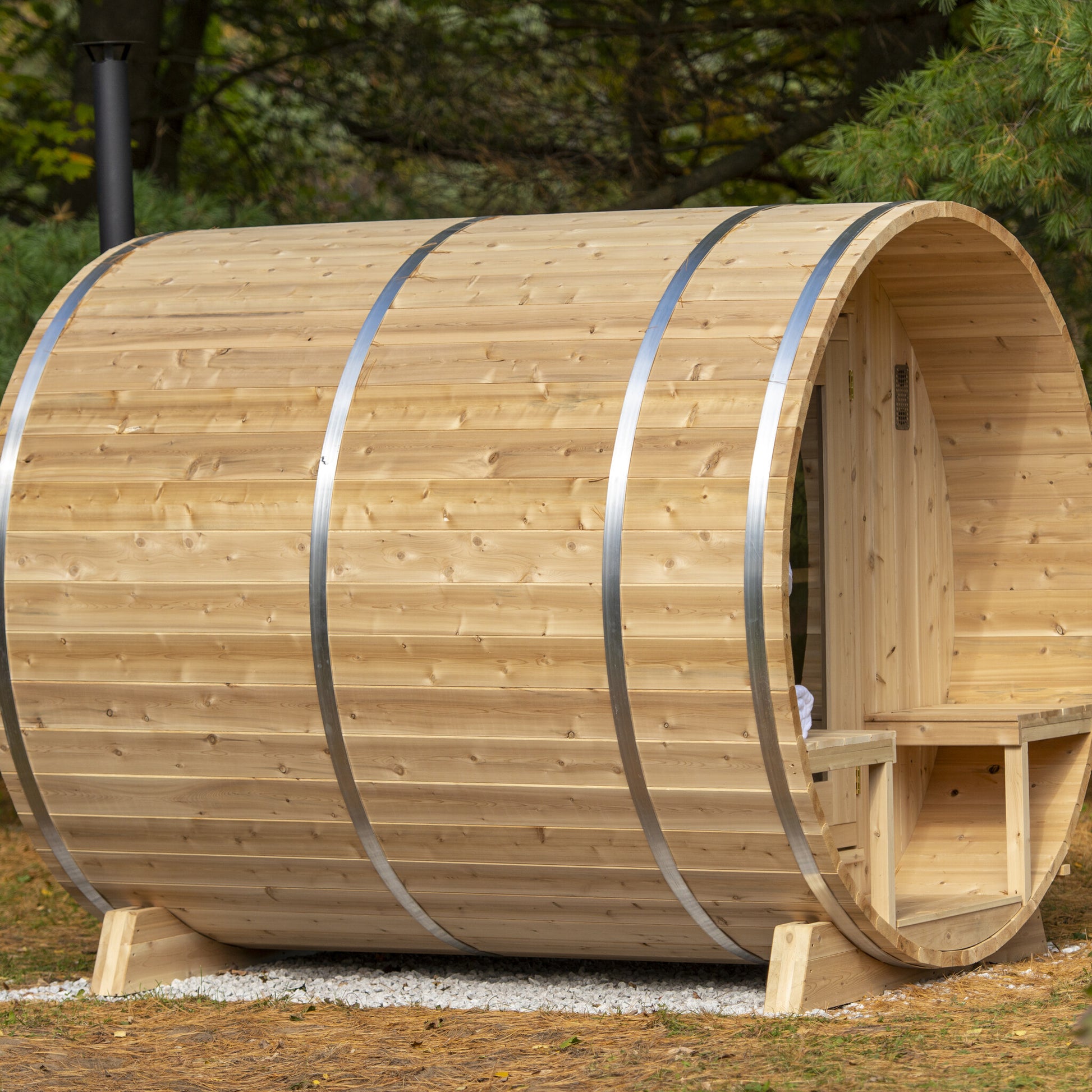 Canadian Timber Serenity 5-person white cedar barrel sauna, side view installed outdoors