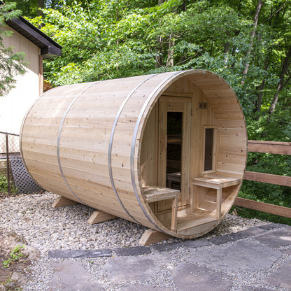 Canadian Timber Tranquility 6-person white cedar barrel sauna, installed in a backyard