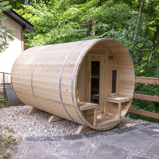Canadian Timber Tranquility 6-person white cedar barrel sauna, installed in a backyard