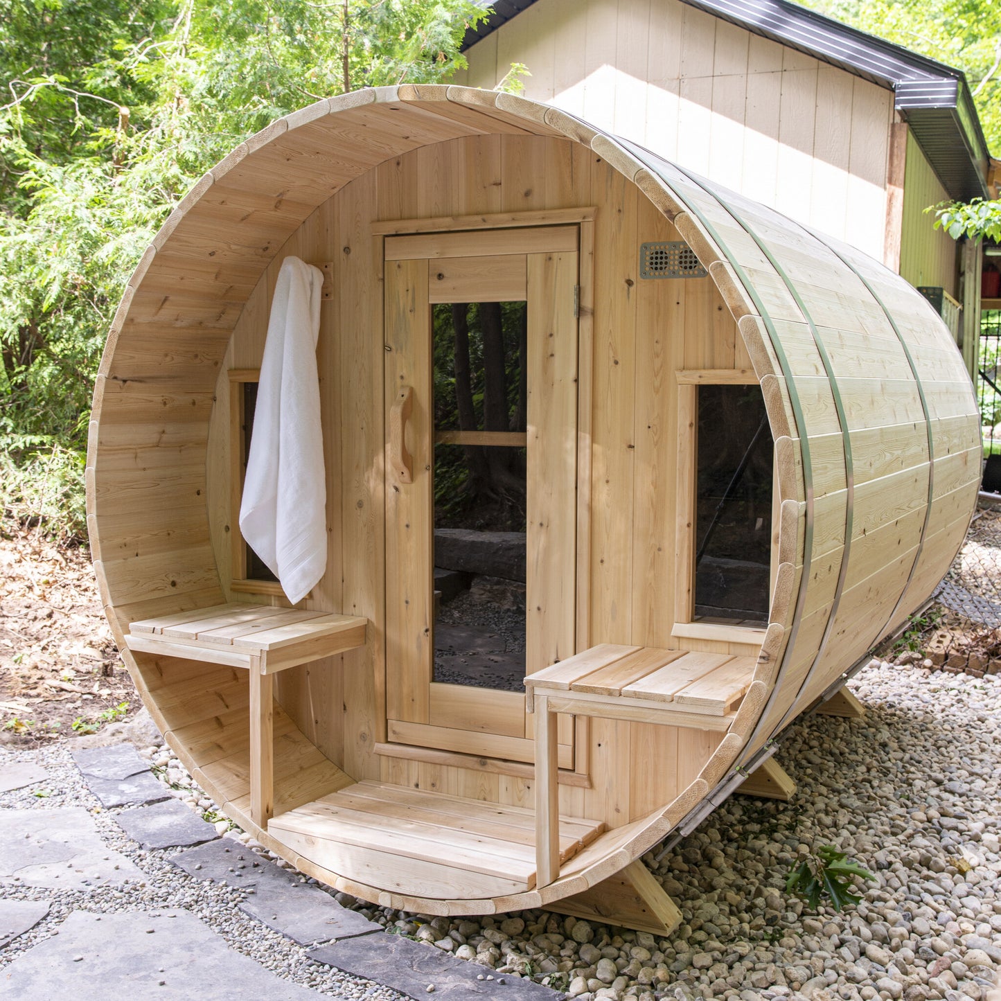 Canadian Timber Tranquility 6-person white cedar barrel sauna, installed in a backyard