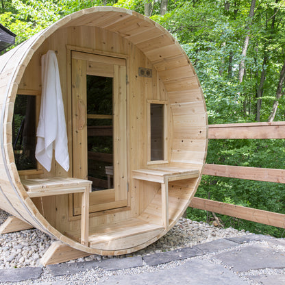 Canadian Timber Tranquility 6-person white cedar barrel sauna, installed in a backyard