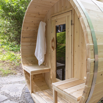 Canadian Timber Tranquility 6-person white cedar barrel sauna, installed in a backyard