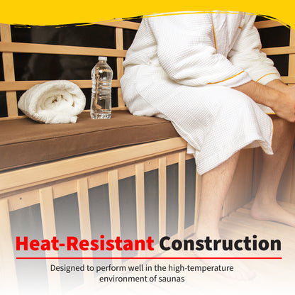 Person in a white robe seated on the HeatWave brown seat cushion on a sauna bench beside a rolled towel and water bottle, with a Heat-Resistant Construction banner